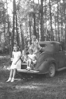 Kids by an old car